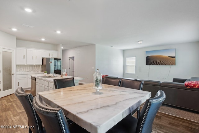 dining area featuring sink and light hardwood / wood-style floors