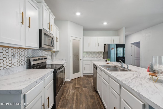 kitchen featuring white cabinetry, sink, dark hardwood / wood-style flooring, decorative backsplash, and appliances with stainless steel finishes