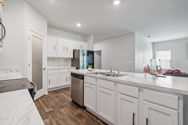 kitchen featuring appliances with stainless steel finishes, backsplash, sink, white cabinets, and dark hardwood / wood-style floors