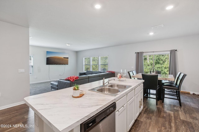 kitchen featuring stainless steel dishwasher, plenty of natural light, a center island with sink, and sink