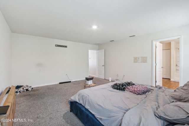 carpeted bedroom featuring ensuite bathroom