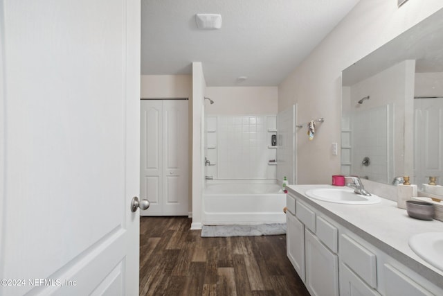 bathroom featuring vanity, hardwood / wood-style flooring, and tiled shower / bath