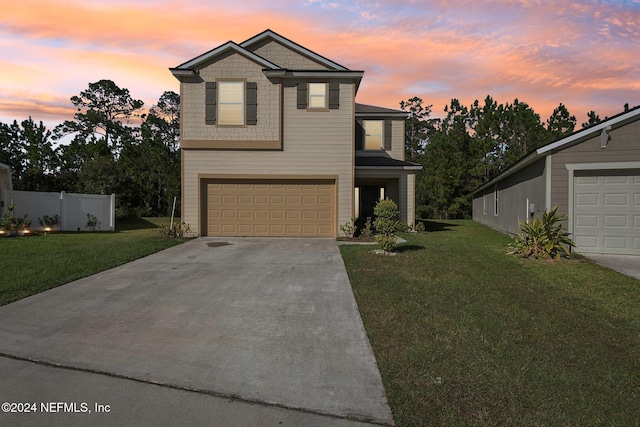 front of property featuring a lawn and a garage