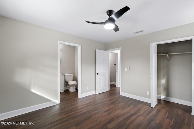 unfurnished bedroom with ensuite bathroom, a closet, ceiling fan, and dark hardwood / wood-style floors