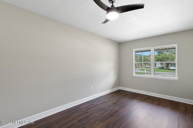 unfurnished room with ceiling fan and dark hardwood / wood-style flooring