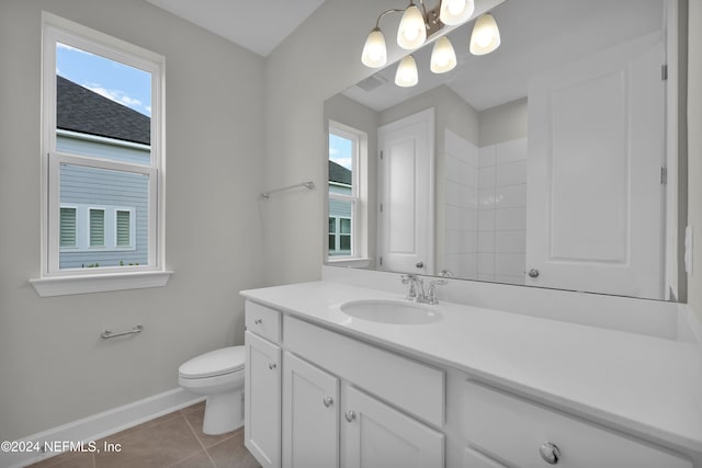 bathroom featuring vanity, tile patterned flooring, and toilet