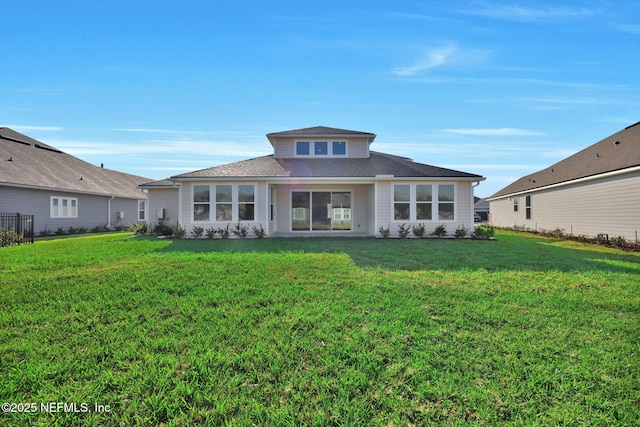 rear view of house with a lawn