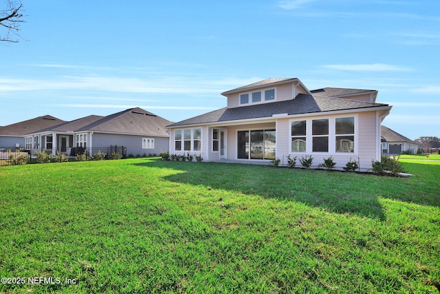 view of front facade with fence and a front lawn