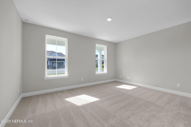 empty room with baseboards and carpet flooring