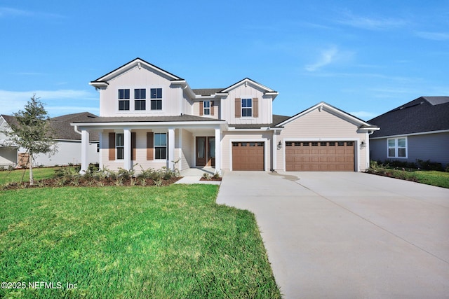 modern inspired farmhouse featuring concrete driveway, covered porch, an attached garage, board and batten siding, and a front yard