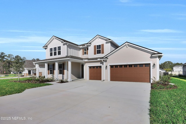 modern farmhouse style home featuring a porch, concrete driveway, board and batten siding, a front yard, and a garage