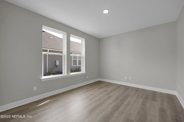 empty room with wood finished floors and baseboards