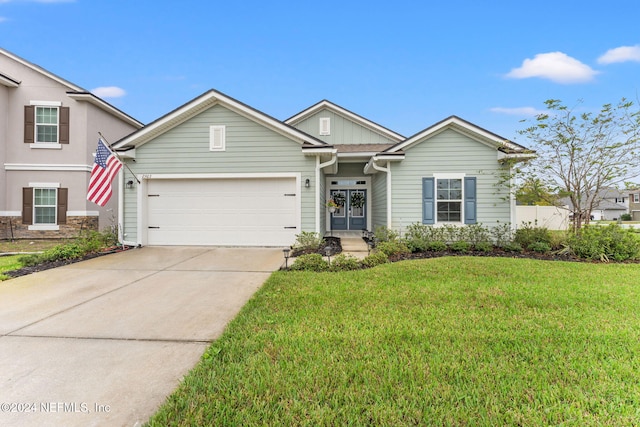 view of front of house featuring a garage and a front lawn