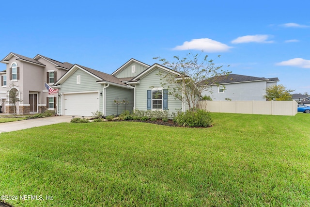 view of front of home featuring a front lawn and a garage