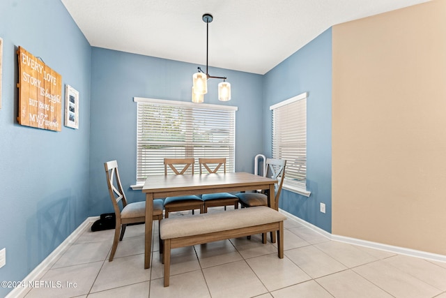 dining space with an inviting chandelier and light tile patterned floors