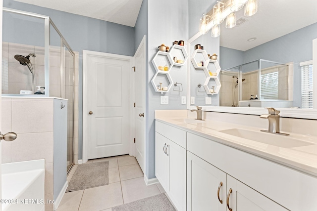 bathroom with tile patterned flooring, vanity, and independent shower and bath