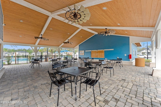 view of patio with a water view and ceiling fan