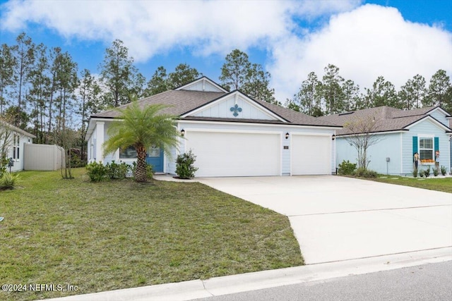 ranch-style house featuring a garage and a front lawn