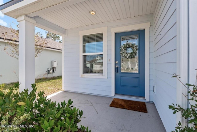 view of exterior entry featuring a porch