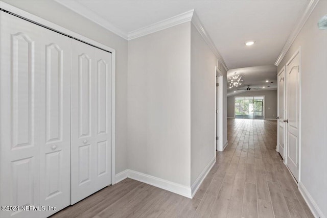 hall featuring light hardwood / wood-style floors and crown molding