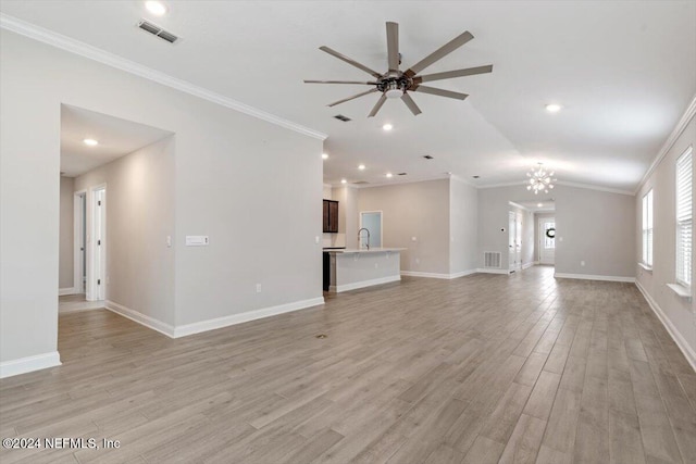 unfurnished living room with sink, ceiling fan with notable chandelier, light hardwood / wood-style floors, and crown molding