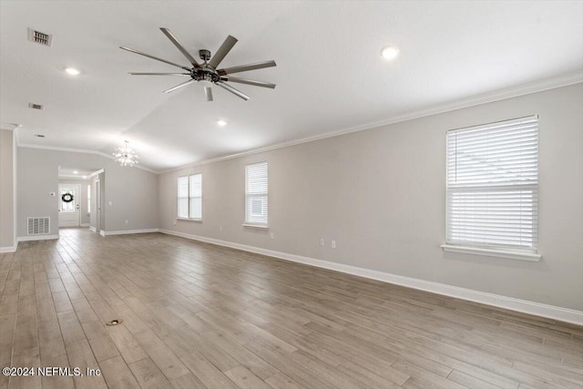 unfurnished living room featuring light wood-type flooring, ceiling fan with notable chandelier, lofted ceiling, and crown molding