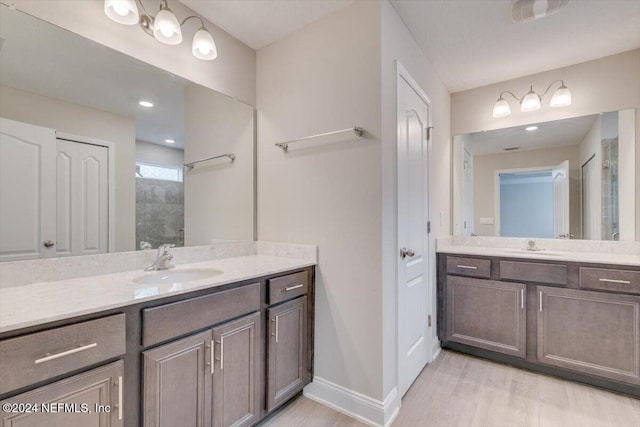 bathroom featuring vanity, hardwood / wood-style flooring, and a shower