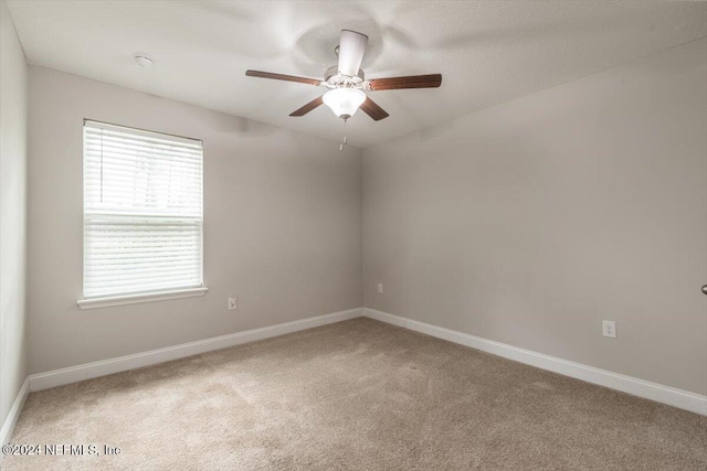 carpeted empty room with ceiling fan