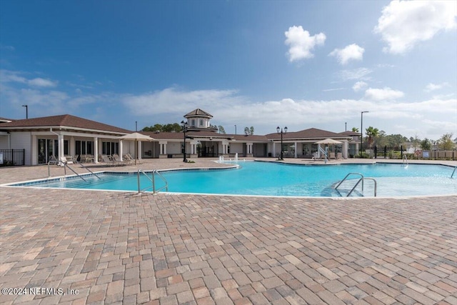 view of swimming pool with a patio