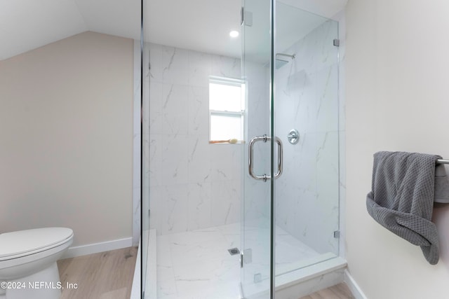 bathroom with a shower with shower door, wood-type flooring, toilet, and lofted ceiling