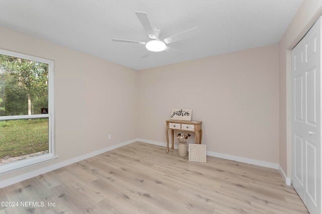 empty room with ceiling fan and light wood-type flooring