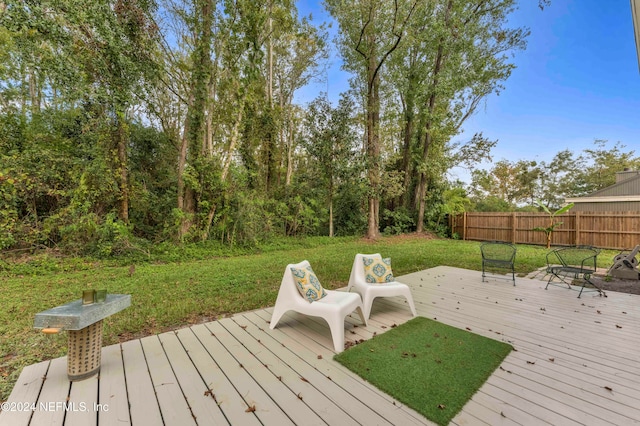 wooden deck featuring a yard