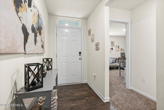 entryway with a textured ceiling and dark hardwood / wood-style floors