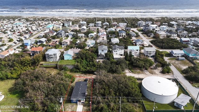 birds eye view of property featuring a water view and a beach view