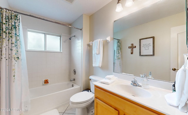 full bathroom featuring vanity, shower / tub combo with curtain, tile patterned flooring, and toilet