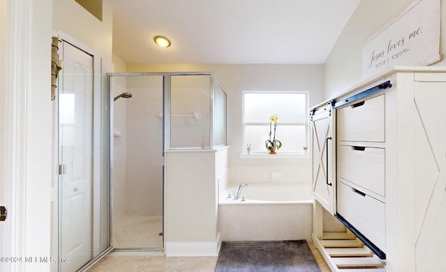 bathroom with tile patterned flooring and separate shower and tub