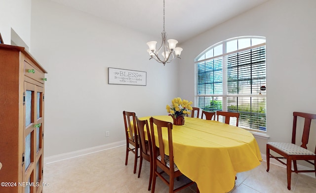 dining space with an inviting chandelier