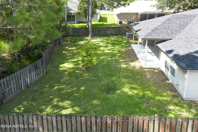 view of yard with radiator and central AC