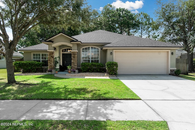 view of front facade featuring a garage and a front lawn