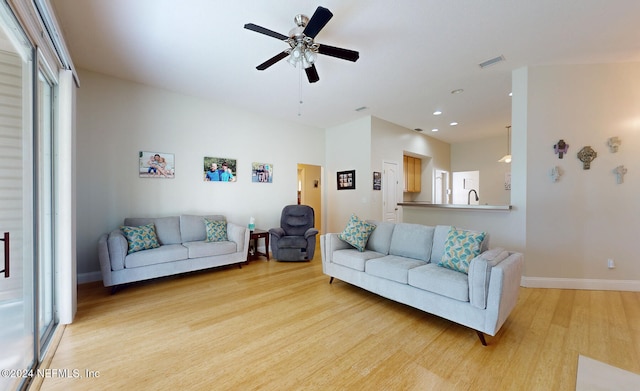 living room featuring ceiling fan and light wood-type flooring