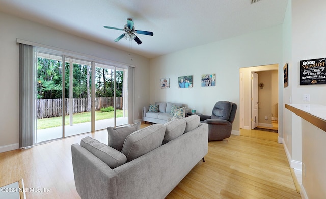 living room featuring light wood-type flooring and ceiling fan