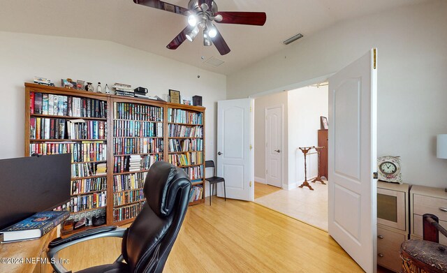 home office featuring light hardwood / wood-style floors, ceiling fan, and vaulted ceiling