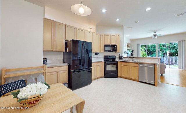 kitchen featuring light brown cabinets, kitchen peninsula, black appliances, and decorative light fixtures