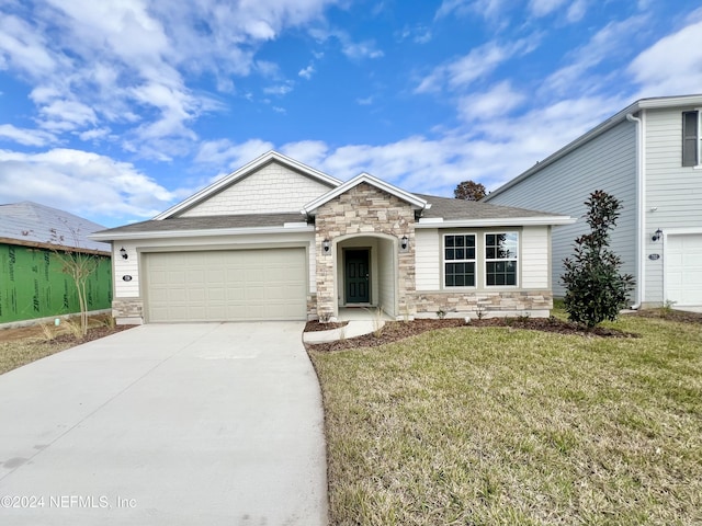 view of front of home featuring a garage and a front yard