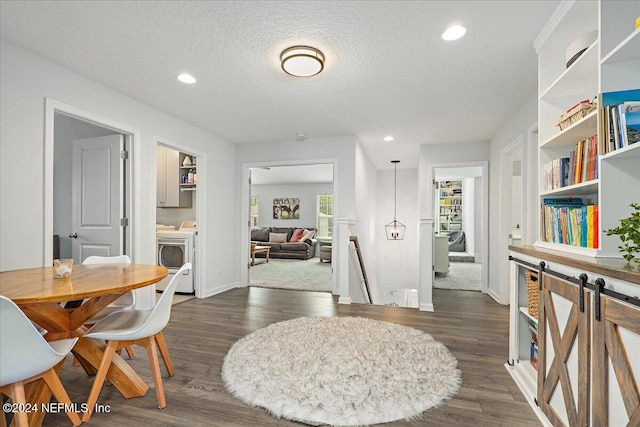 dining room with washer / dryer, a textured ceiling, and dark hardwood / wood-style flooring