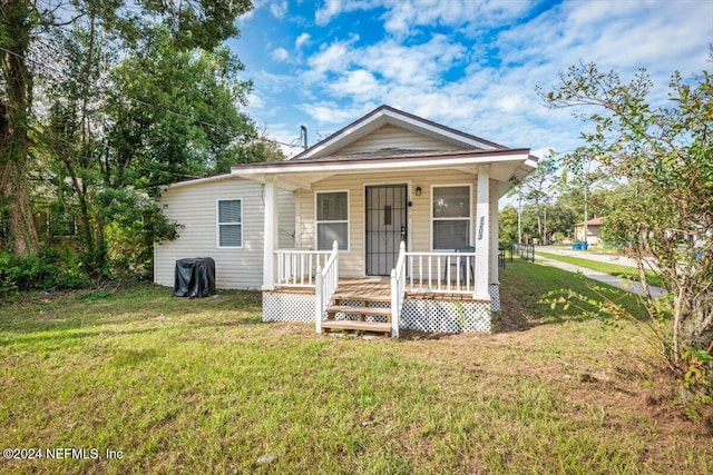 bungalow-style house with a porch and a front yard