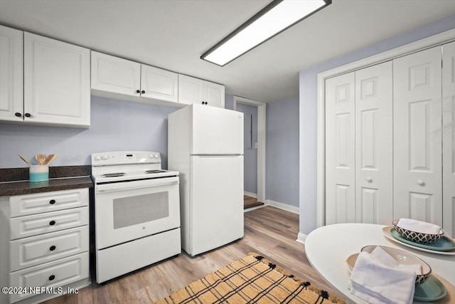 kitchen with white cabinets, light hardwood / wood-style floors, and white appliances