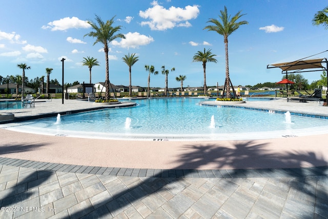 view of swimming pool featuring pool water feature and a patio area