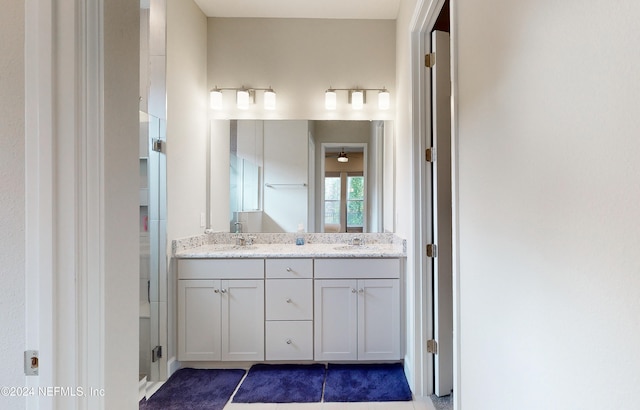 bathroom with tile patterned flooring and vanity