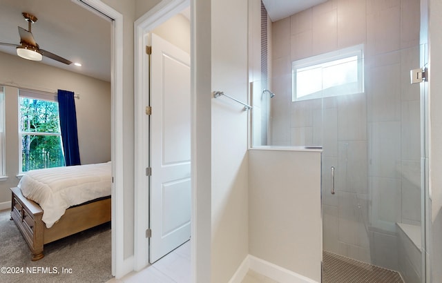 bathroom with ceiling fan and a shower with door